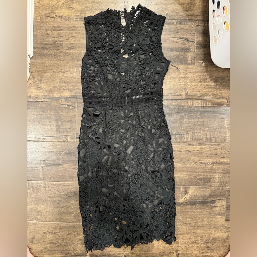 Black dress with crochet look and gold zipper